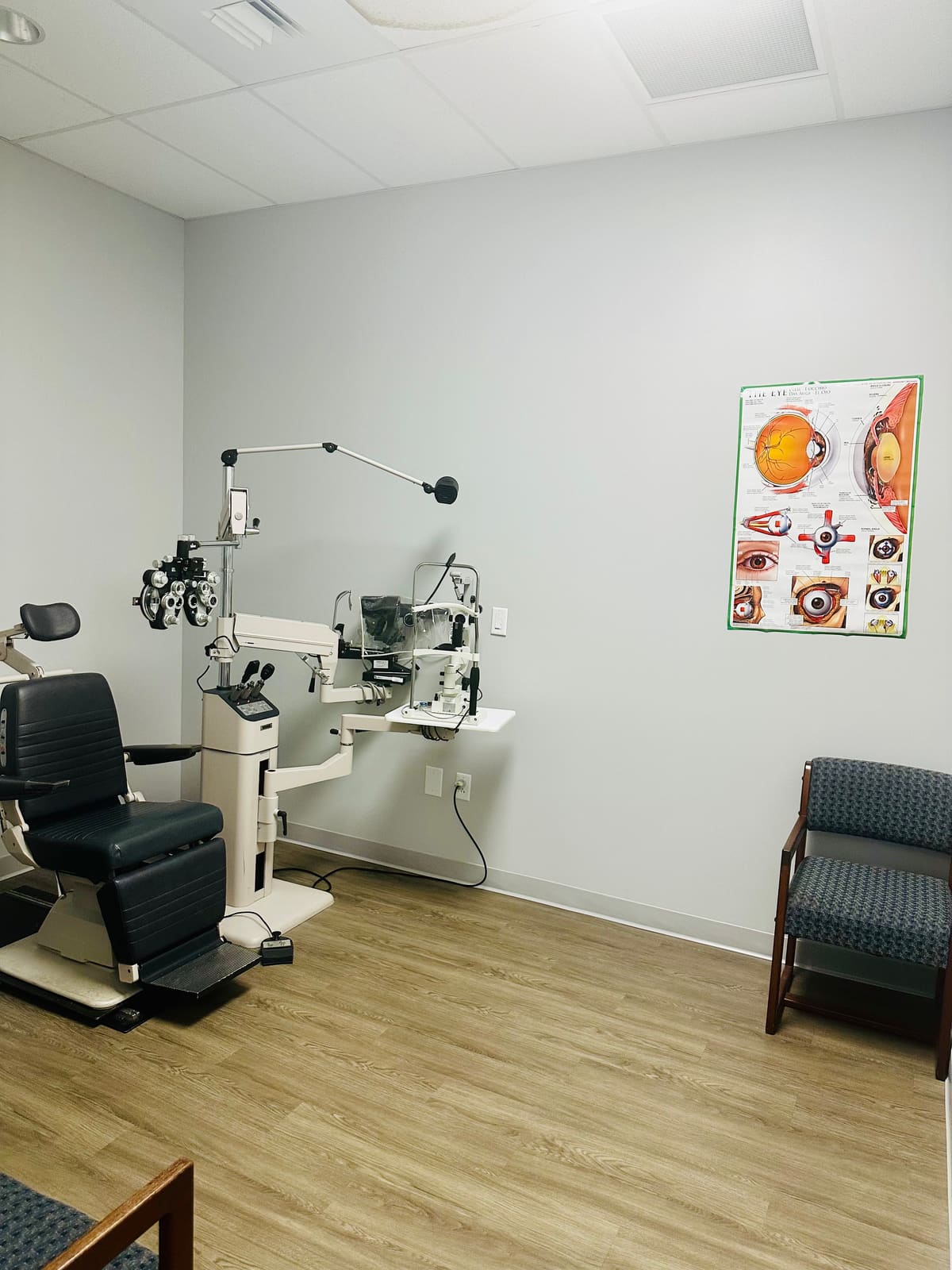 Exam room at Fort Jackson Eye Center with eye exam equipment and a poster of eye anatomy