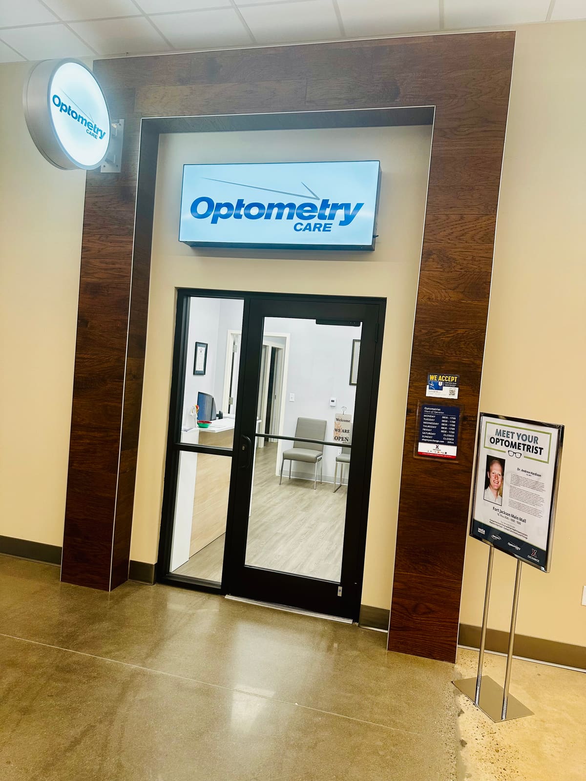 Glass-door entrance to the eye care office, with the reception area visible inside