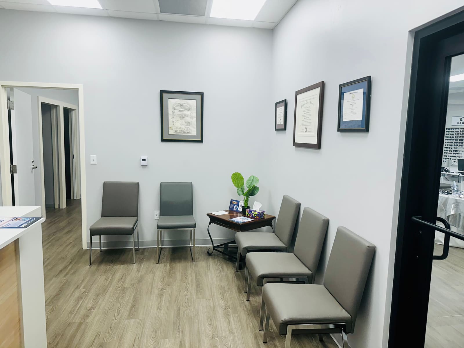 Waiting area at Fort Jackson Eye Center with seating and framed diplomas on the wall